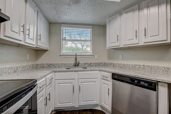 Designer kitchens with granite counters, curved faucets & silver cabinet pulls